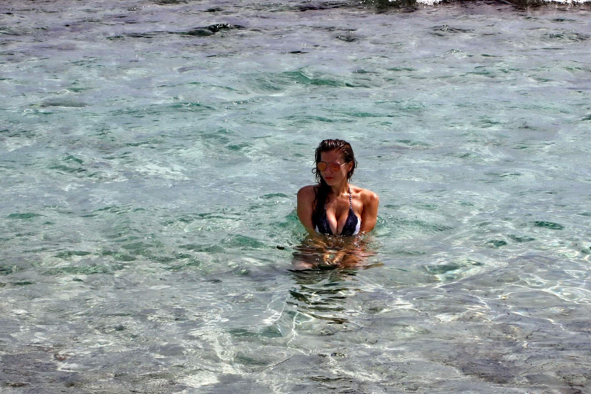 Imogen Thomas shows off her curvy body wearing a skimpy monochrome bikini on a b