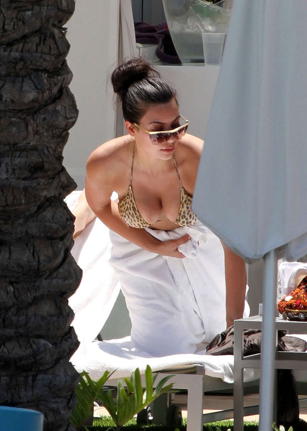 Kim Kardashian in leopard print bikini on pool paparazzi pictures and exposing h #75345117