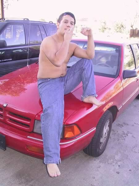 Amature guy posing by his red car #77009743