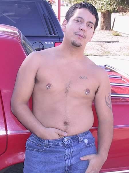 Amature guy posing by his red car #77009750