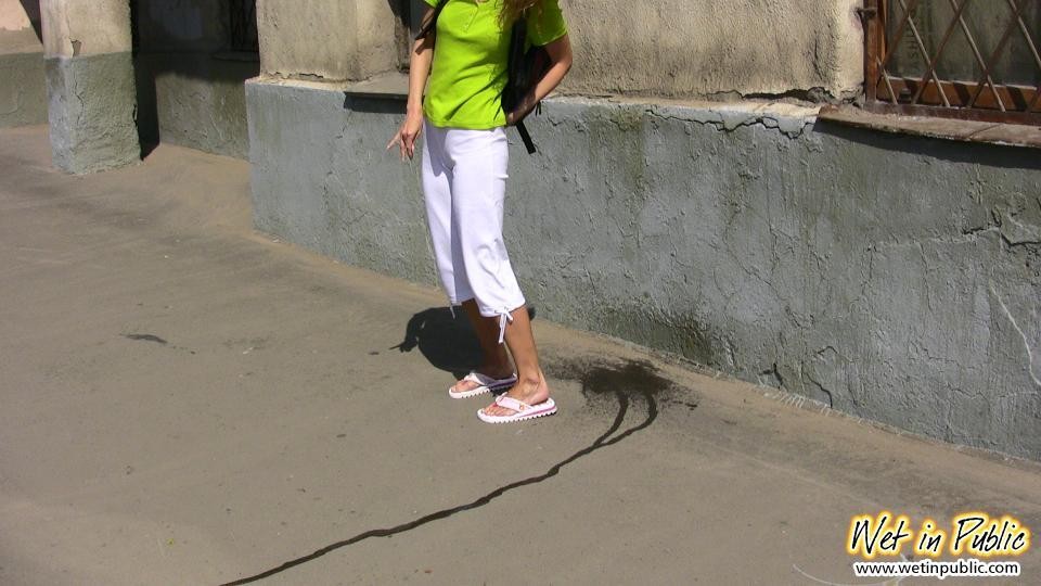 Gedemütigte Schlampe, die gerade ihre weiße Hose direkt auf die Straße gepinkelt hat
 #78594902