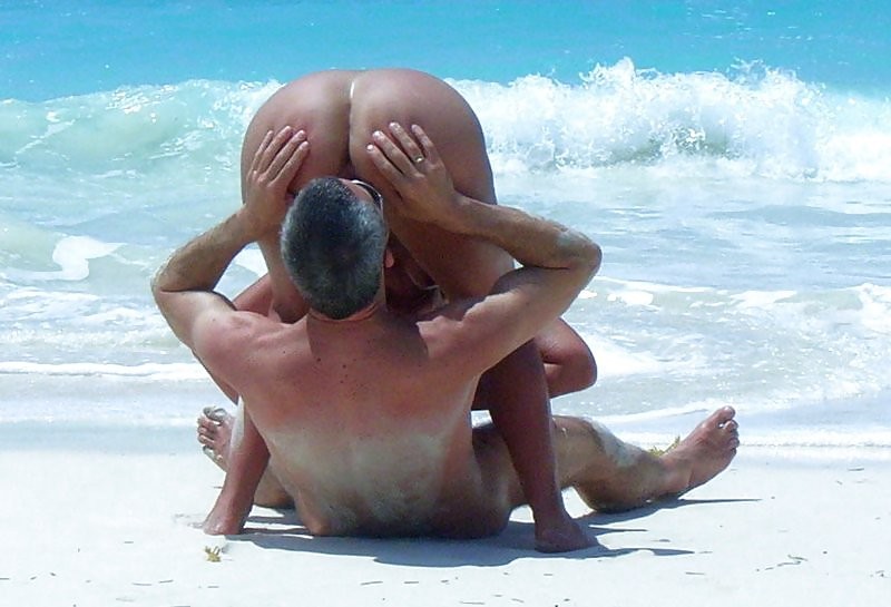 Naked couple having oral sex at a public beach #72241902