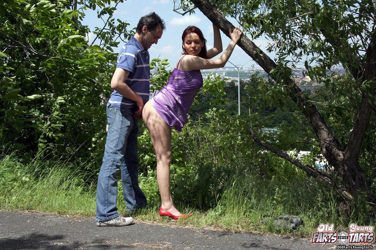 Old guy screwing a younger chick in an open field publicly #78607564
