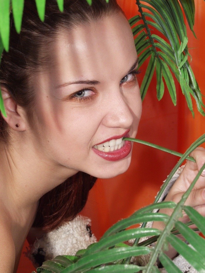 Cute petite teen stripping behind a palm tree #74858977