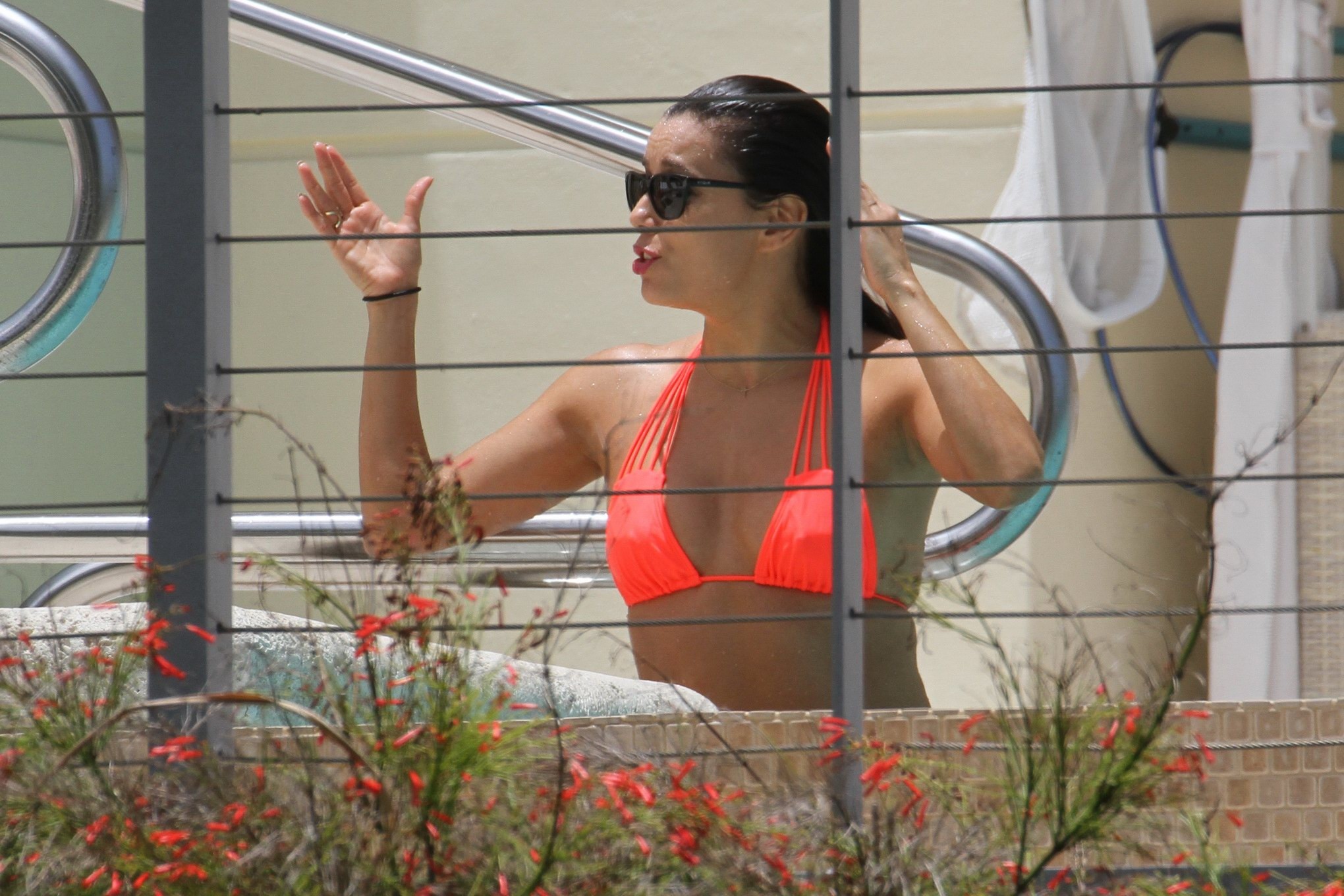 Eva Longoria shows nipple pokies in orange bikini poolside #75160148