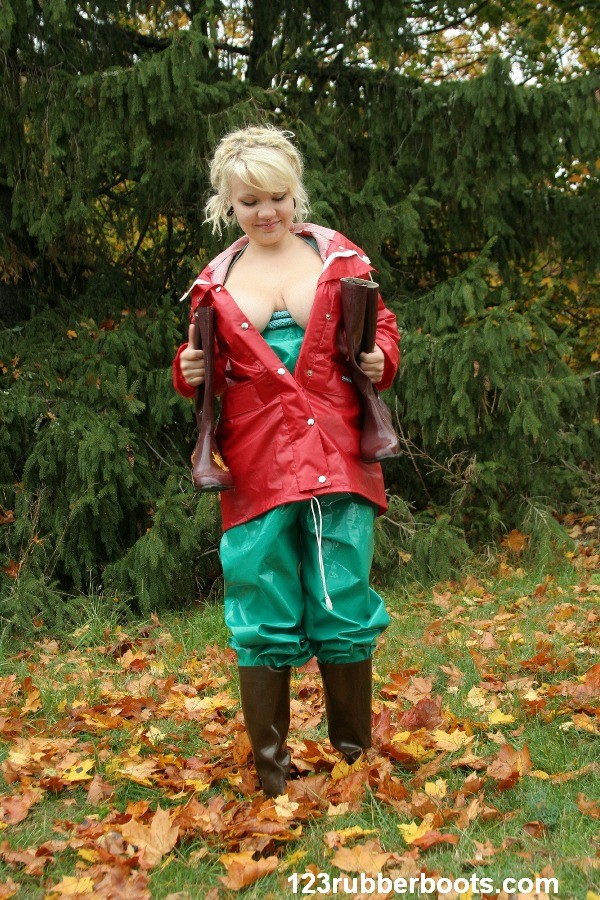 Big boobs girl in rubber rainwear fetish fun outdoors. #73253341