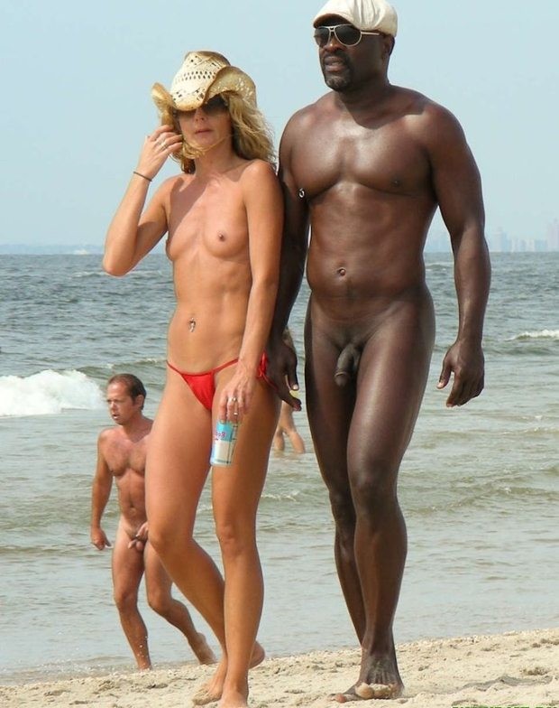 Amigos nudistas retozan en una playa nudista
 #72236365