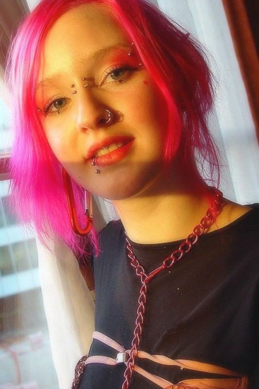 Pink Haired Gothic Fetish Chick Showing Off  Her Pierced Boobs