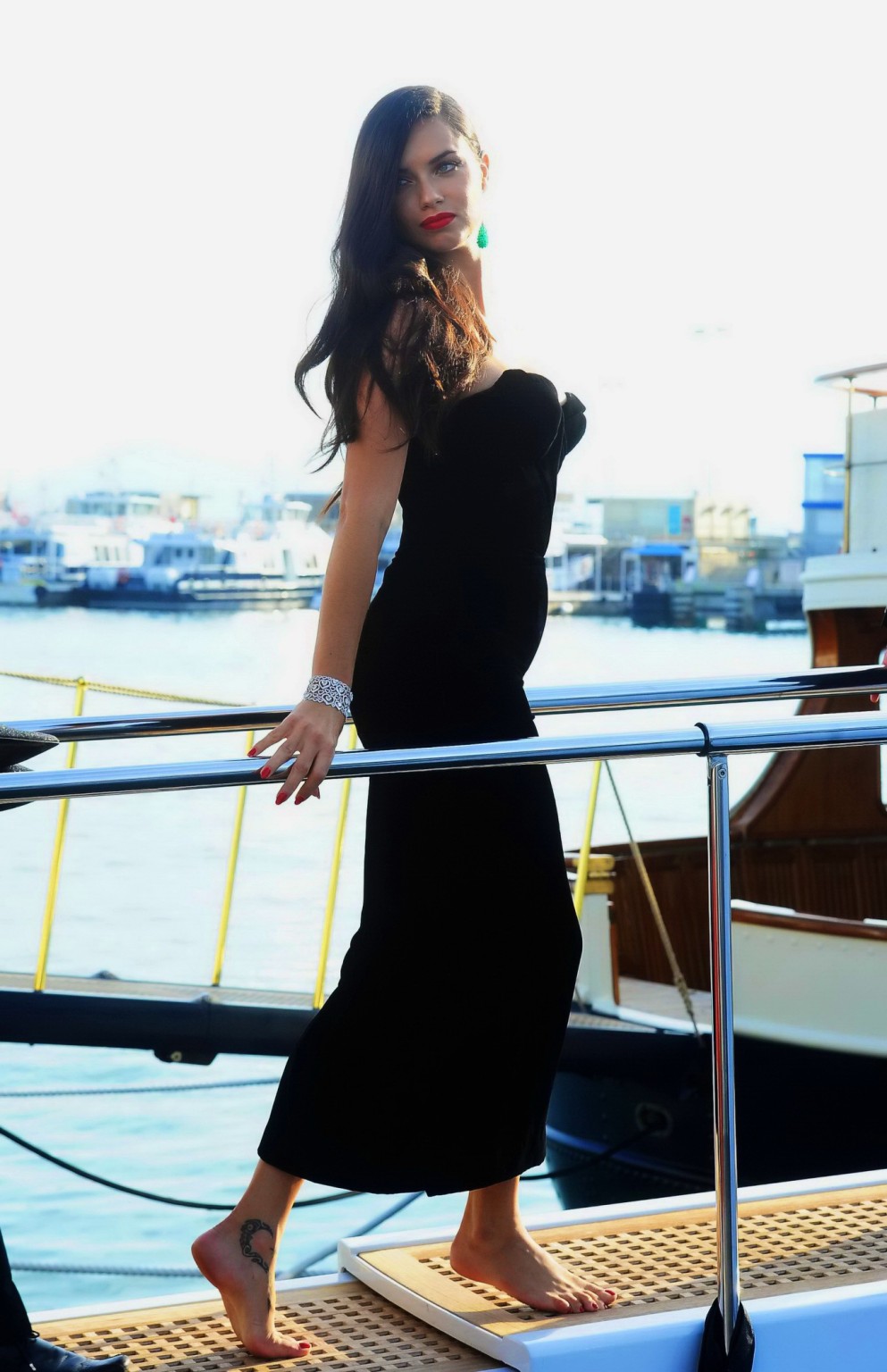 Adriana Lima busty in black strapless dress boarding on a yacht in Cannes #75163542