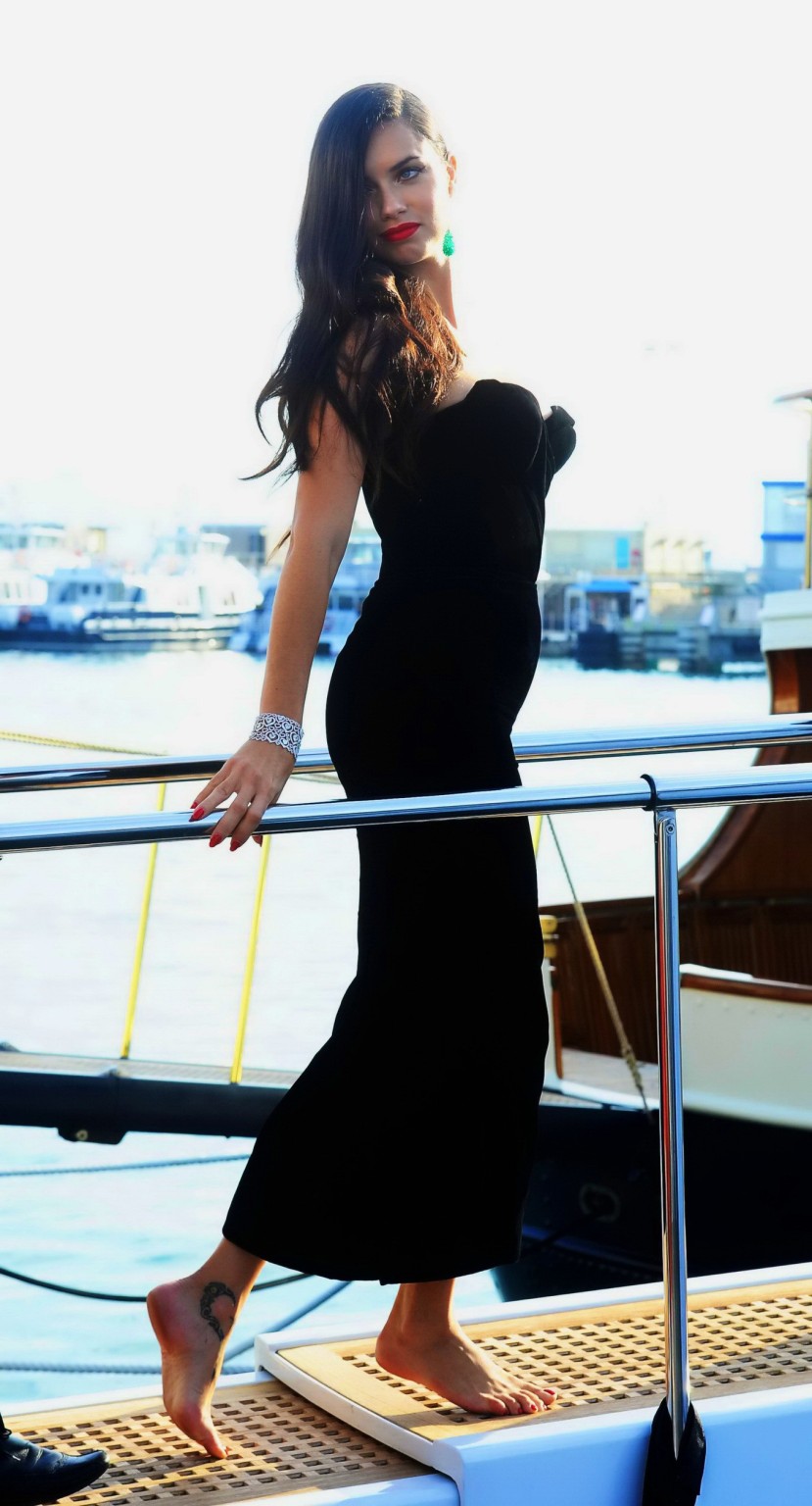 Adriana Lima busty in black strapless dress boarding on a yacht in Cannes #75163545