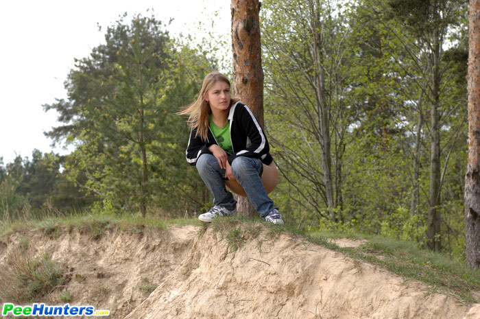 Beautiful teen plays watersports on a quiet forest glade #78692873