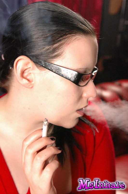 Cute teen in glasses smokes a menthol cigarette #74860243