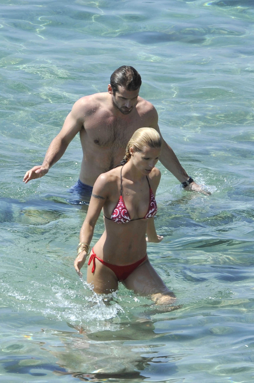 Michelle Hunziker busty wearing a skimpy bikini on the beach in Miami