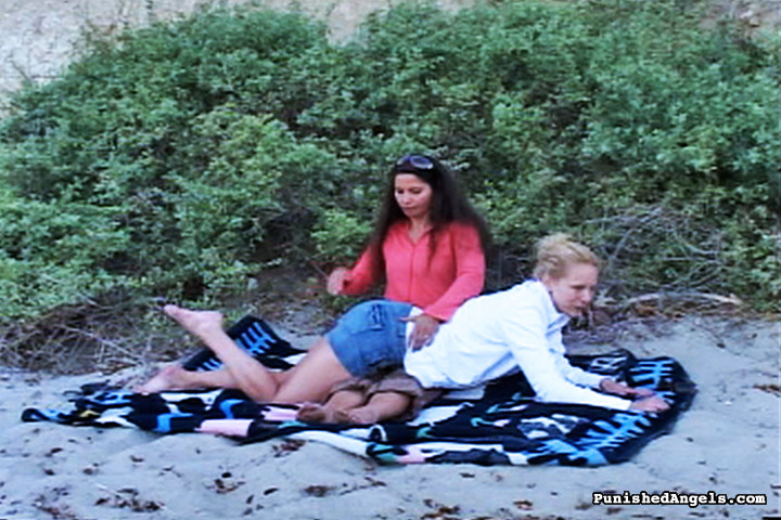 Brunette woman spanking blondes ass at the beach #70481374