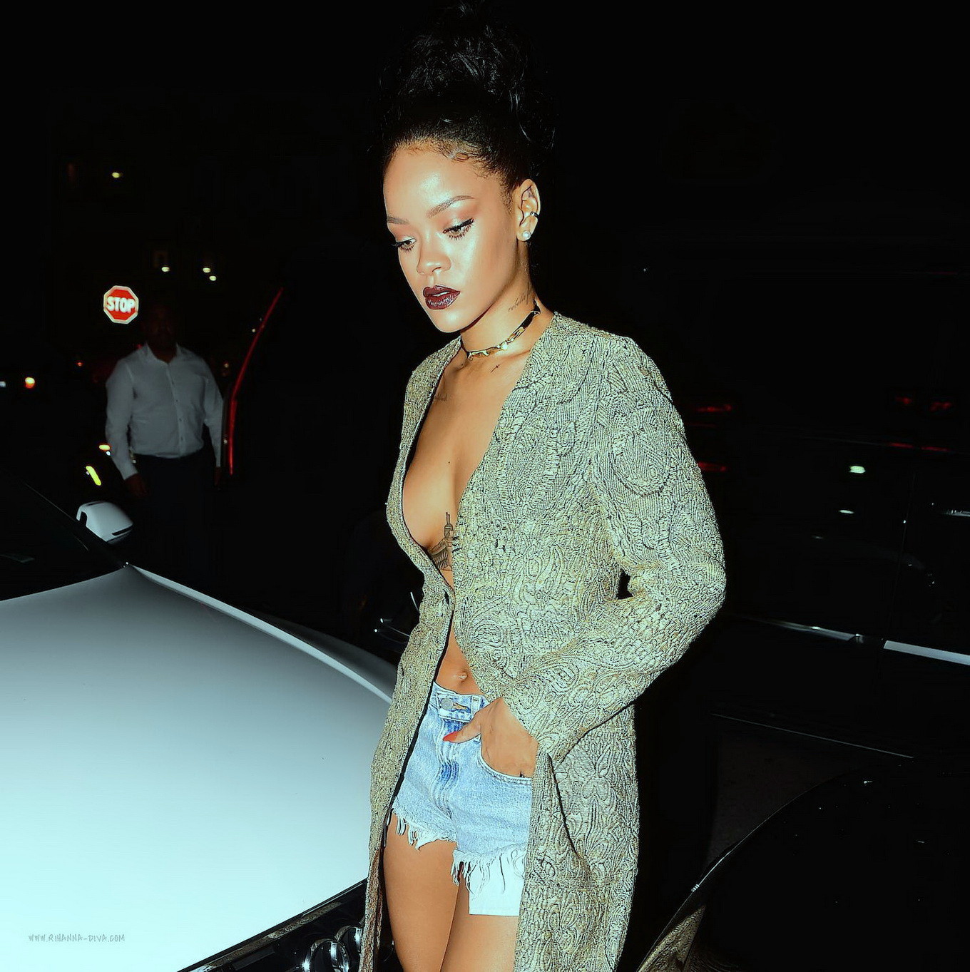 Rihanna wearing only denim shorts under unbuttoned coat while leaving Giorgio Ba #75169417