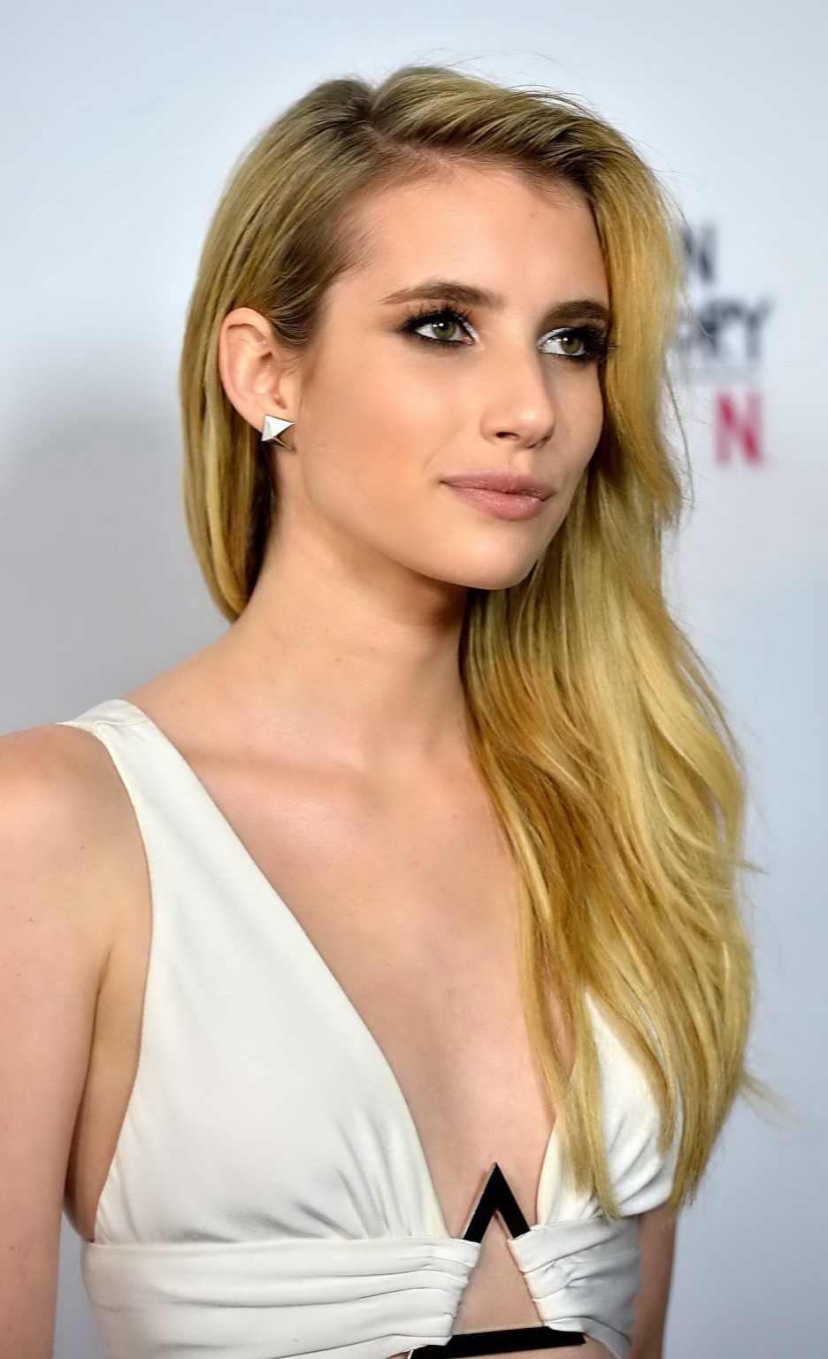 Emma Roberts braless showing huge cleavage in a tight white dress at American Ho #75216706
