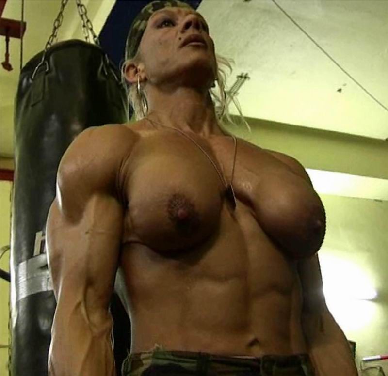 female bodybuilder showing off her muscles #76491922