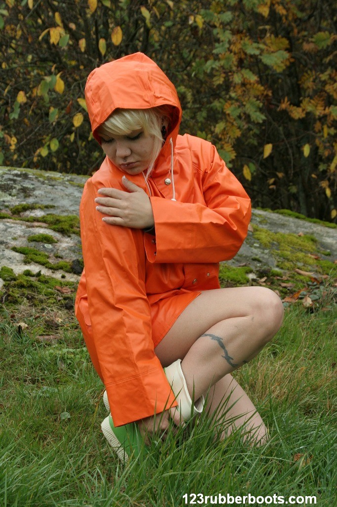 Sexy girl with big breasts outdoors in colorful rainwear #73093719