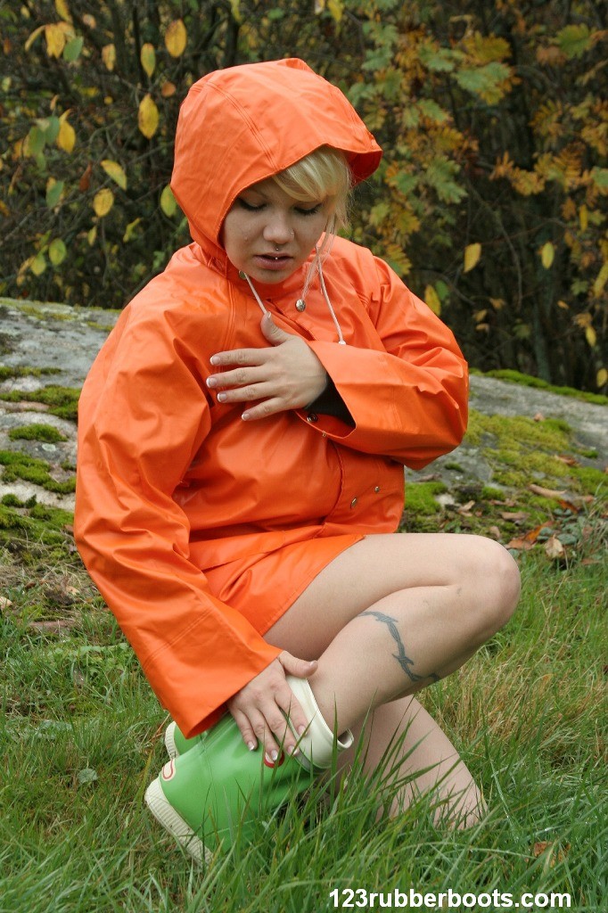 Sexy girl with big breasts outdoors in colorful rainwear #73093727