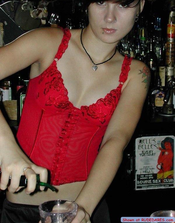 Barmaid strips behind the bar #67513021