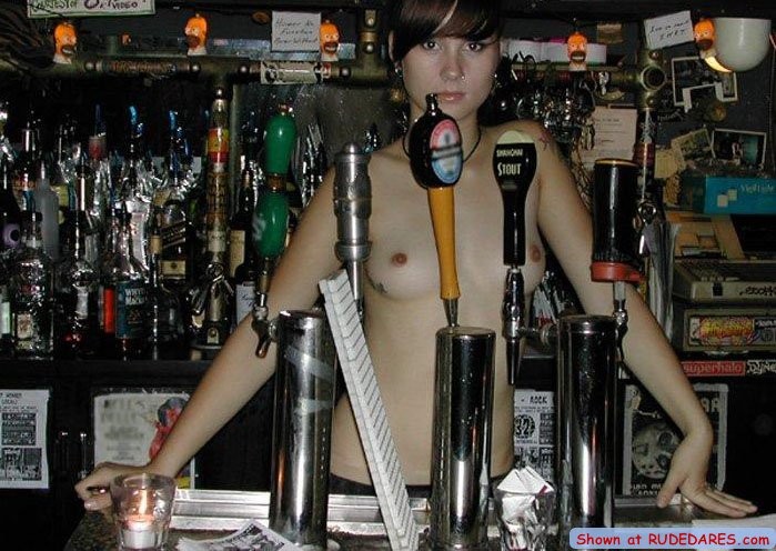 Barmaid strips behind the bar #67513050