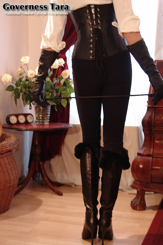 Twisted corsetted domina poses in spike heel leather boots #72184564