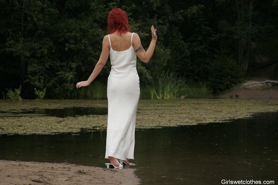 Sexy redhead in a wet evening dress #76650403