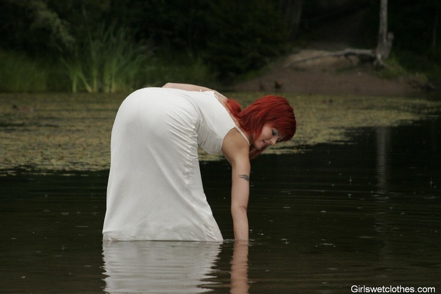 Sexy redhead in a wet evening dress #76650415