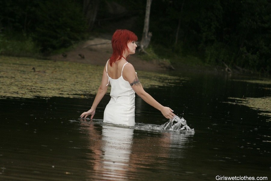 Sexy redhead in a wet evening dress #76650501