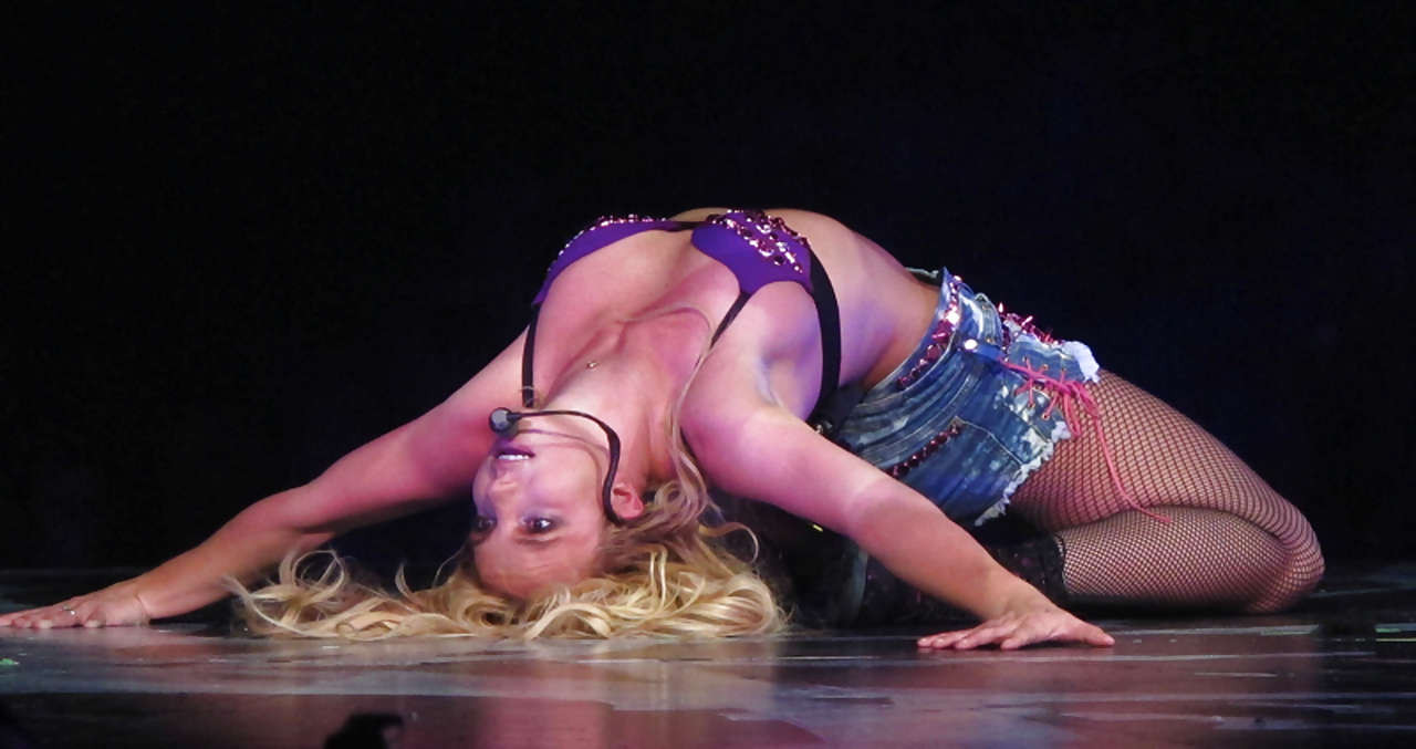 Britney Spears in fishnets and shorts spreading her legs on stage #75299124
