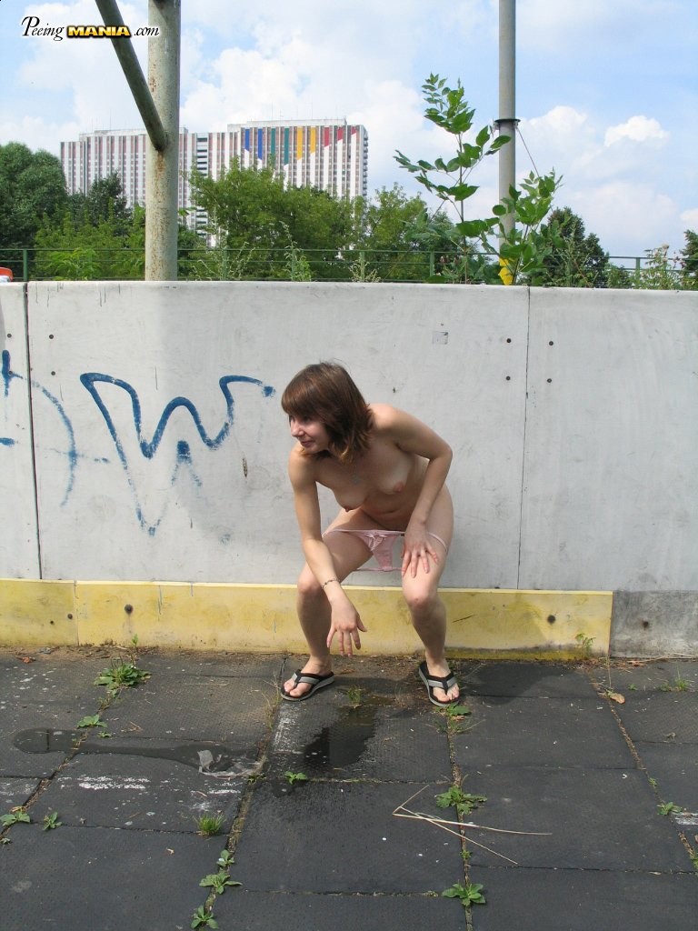 Impudent naked chickie does a piss and shows off in a public place #76565880