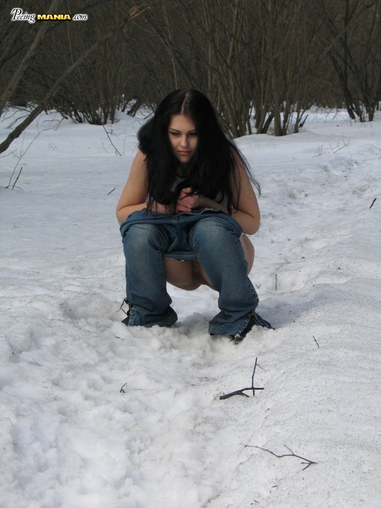 Crazy longhaired brune experiments with her pee in the winter woods #76565824