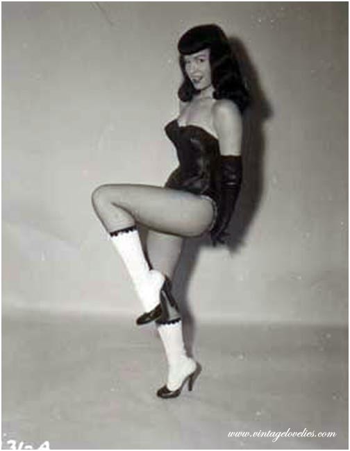 Pin-up star Bettie Page showing her sexy vintage stockings #76521488