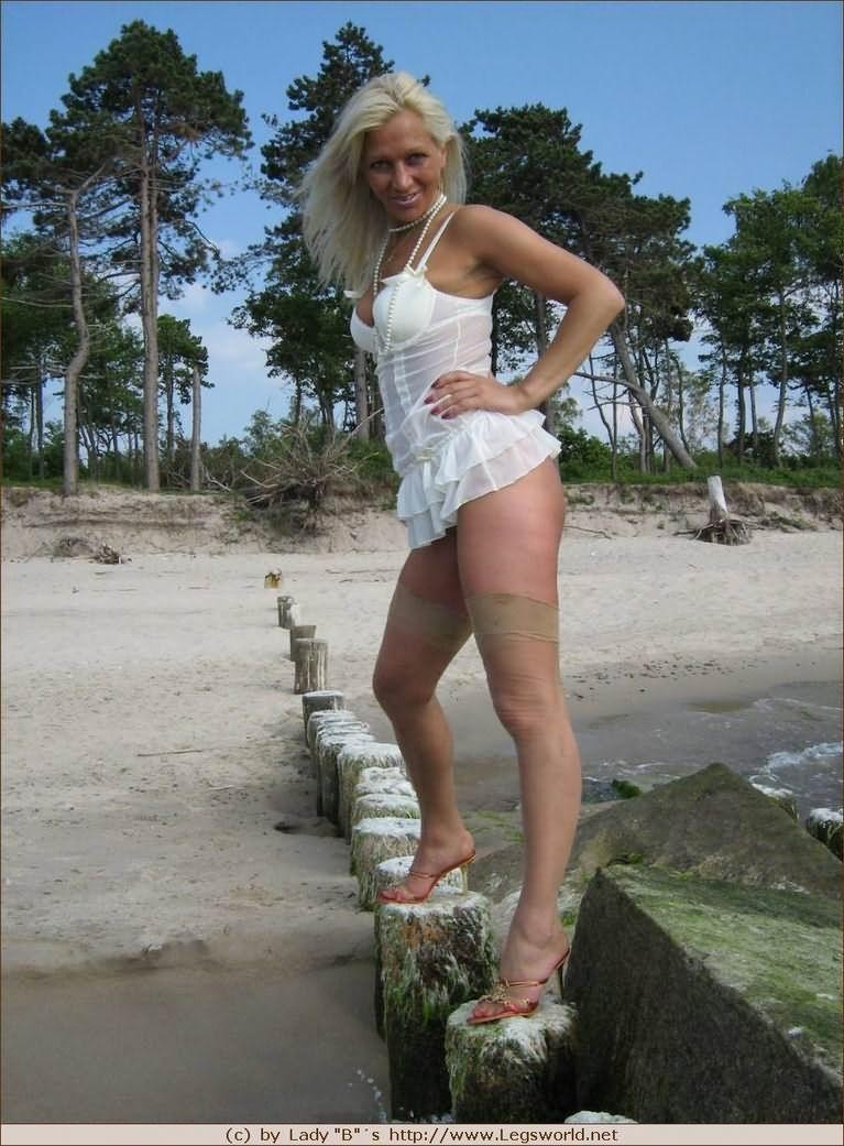 Signora tedesca amatoriale con gambe lunghe in calze di nylon in posa sulla spiaggia
 #78027770