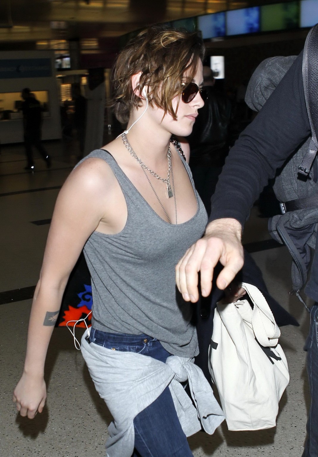Kristen Stewart busty wearing a gray tank top at LAX Airport #75171983