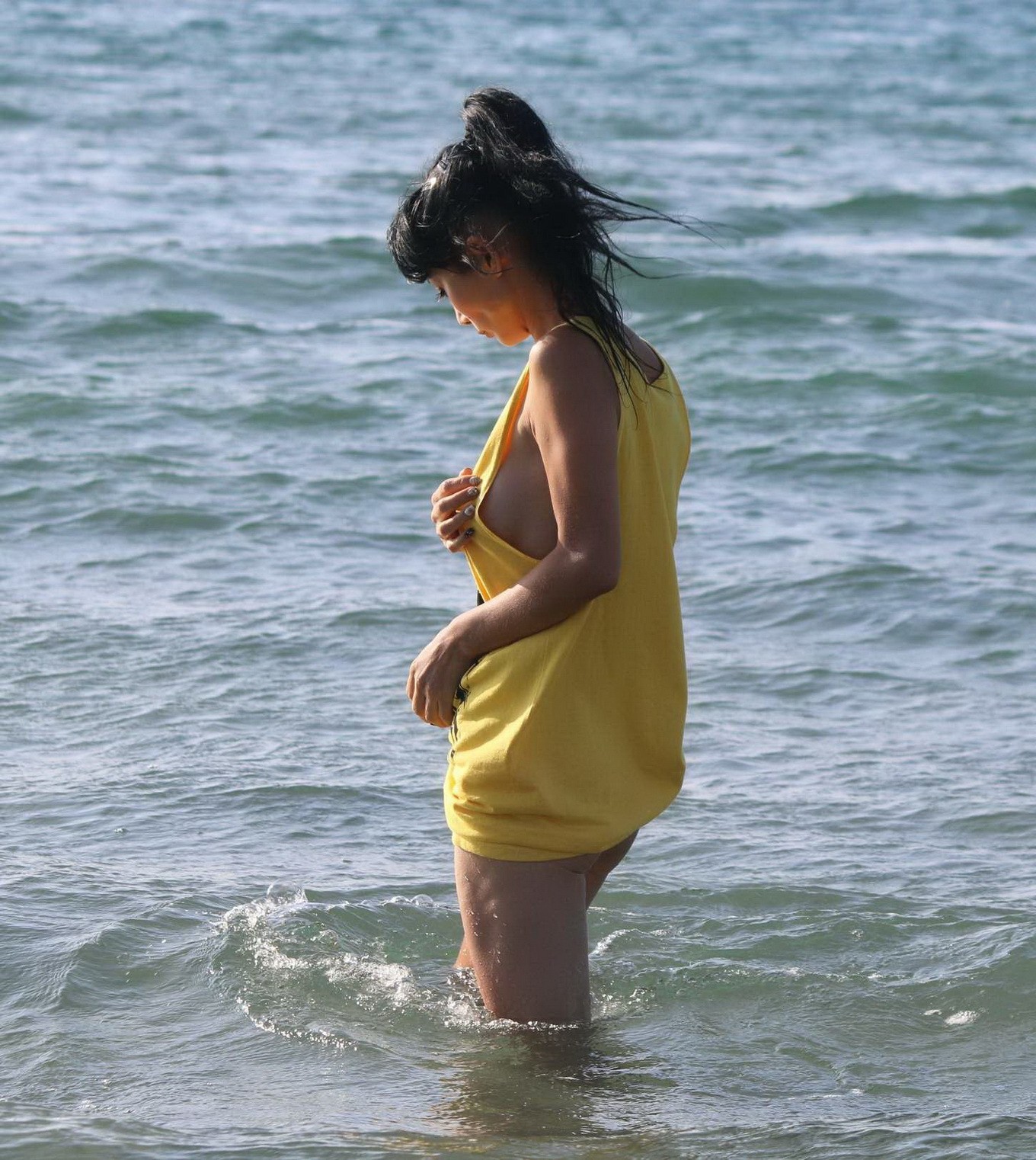 Bai Ling shows sideboob and pokies in wet tshirt and bikini bottom at the beach  #75179094