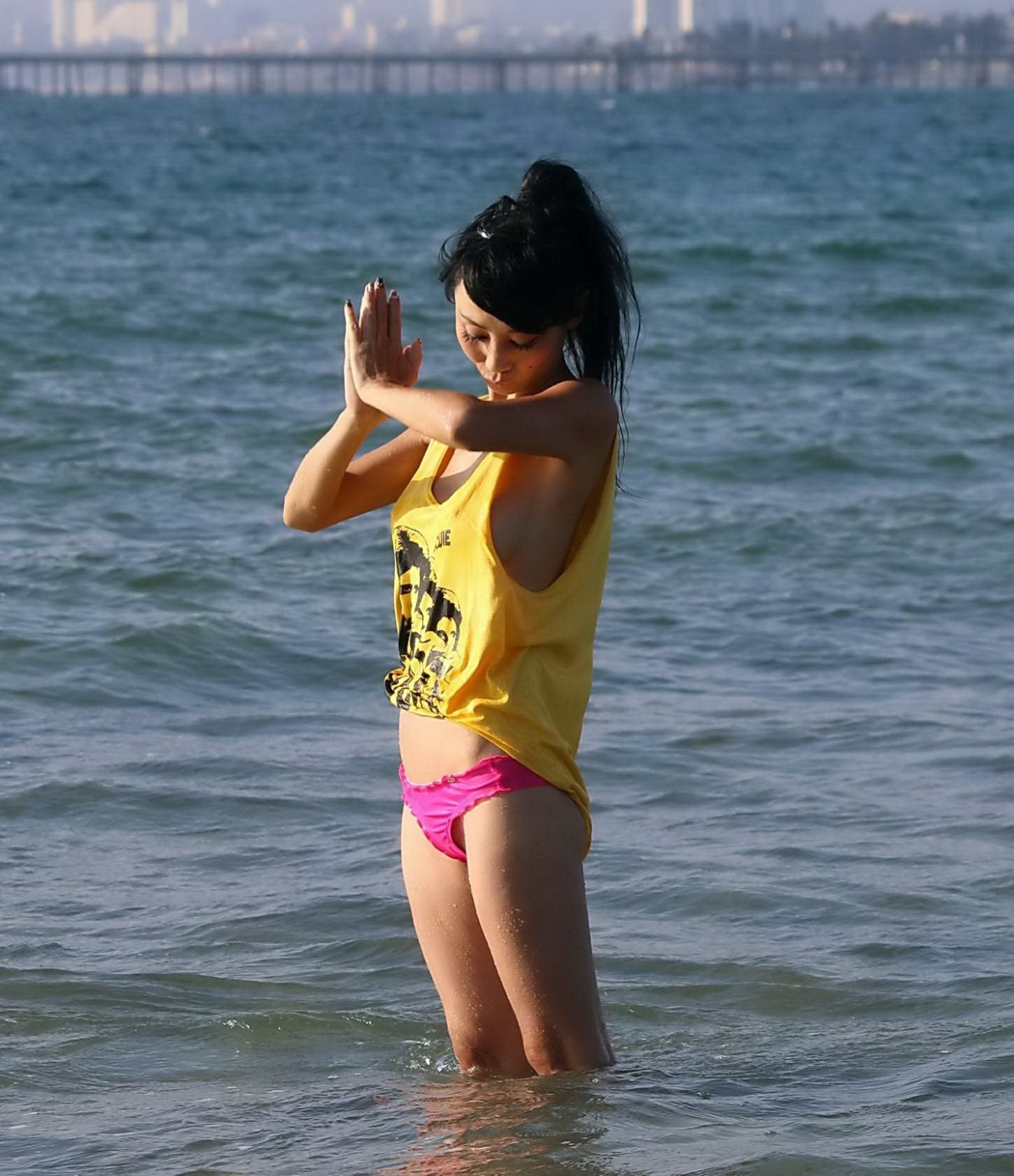 Bai Ling shows sideboob and pokies in wet tshirt and bikini bottom at the beach  #75179120