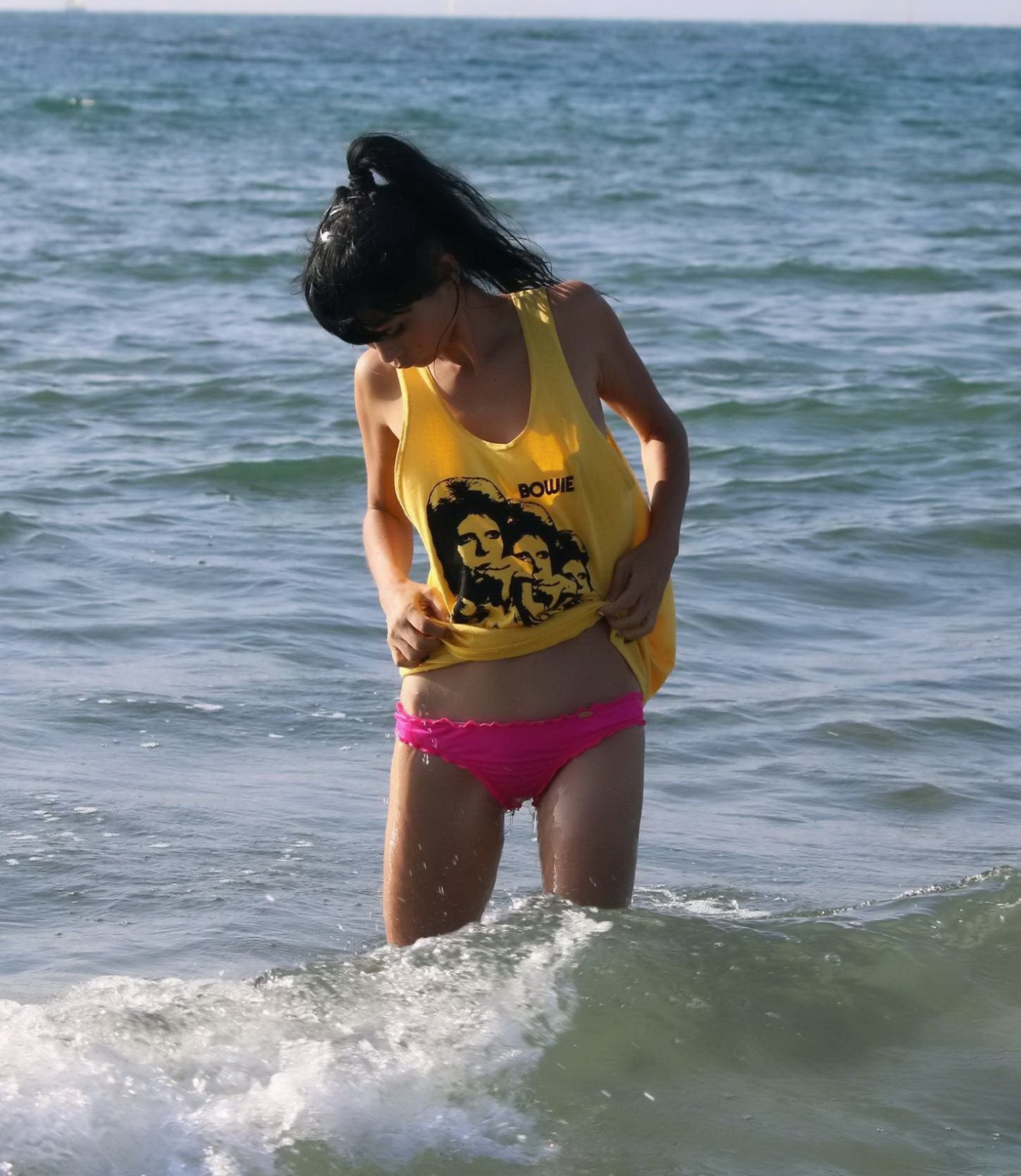 Bai Ling shows sideboob and pokies in wet tshirt and bikini bottom at the beach  #75179122