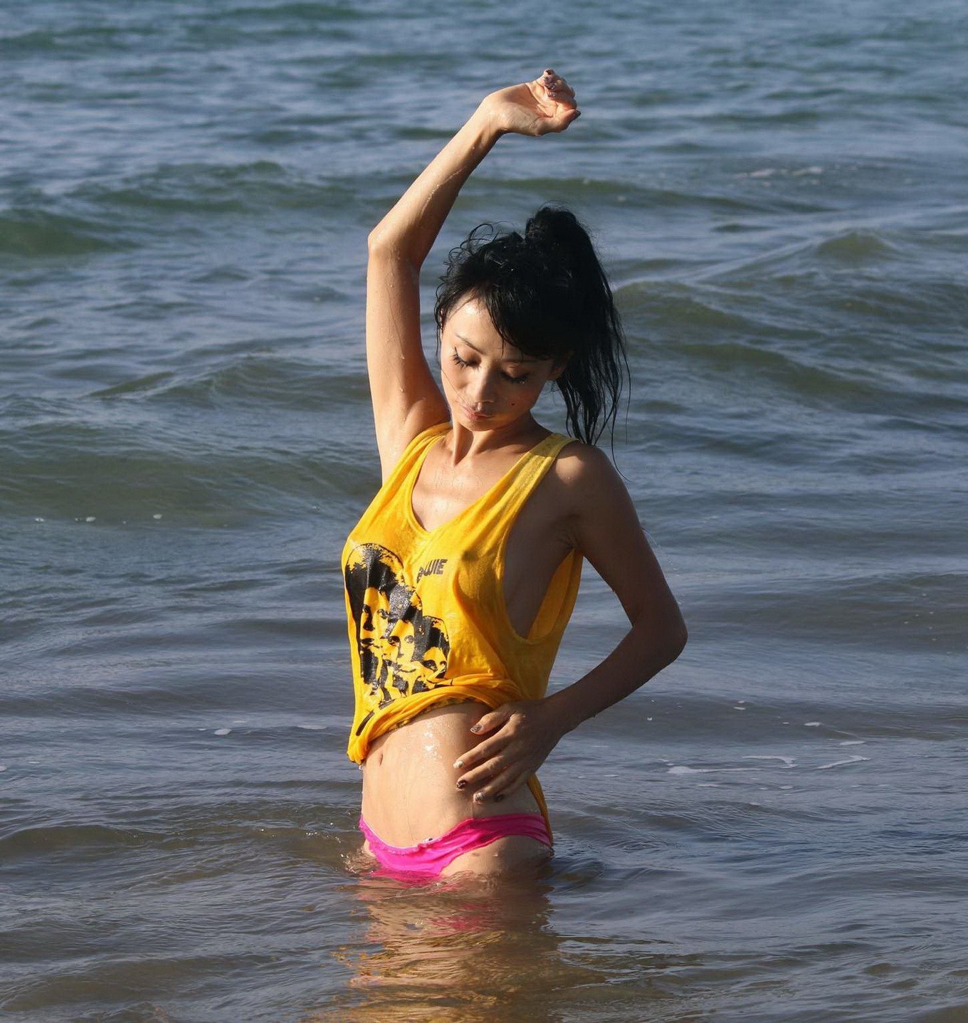 Bai Ling shows sideboob and pokies in wet tshirt and bikini bottom at the beach  #75179140