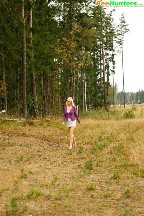 Blonde with tattooed legs pees near forest edge #78692856
