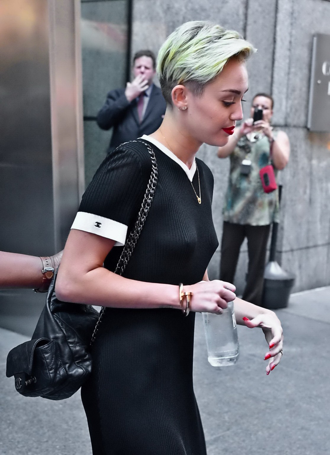 Miley Cyrusが黒の透明なドレスで胸を見せている。
 #75224532