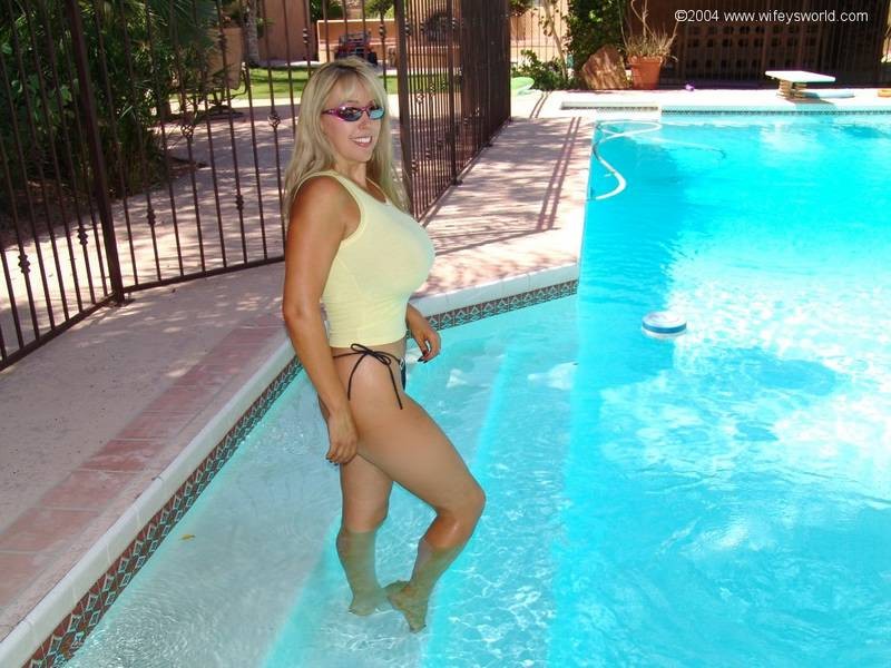 Busty blonde dripping wet poolside #67107910