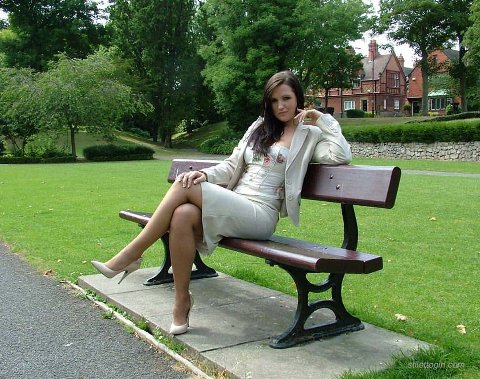 Stiletto girl in stockings posing in the park #78019617