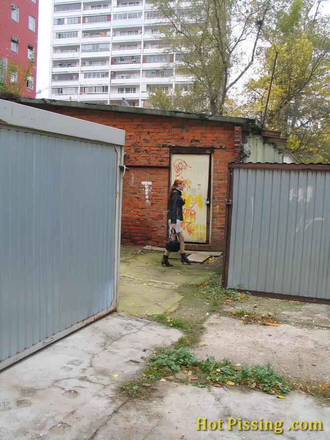 Hidden camera photos of a redhead girl having a pee behind a building #76573223