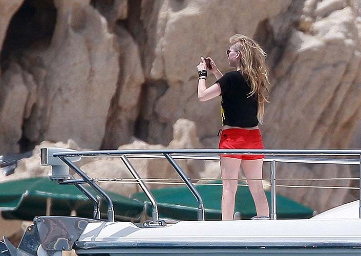 Avril Lavigne exposing sexy bikini body in green bikini on yacht #75255926