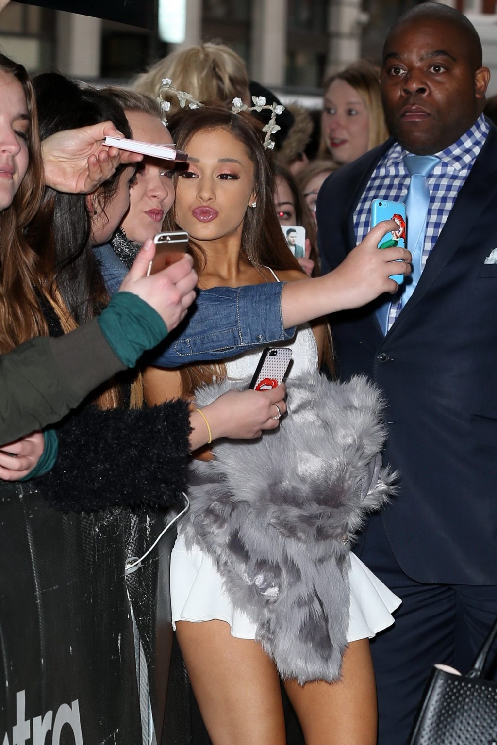 Ariana Grande in tiny white mini skirt and belly top arriving at BBC Radio 1 Stu #75179348