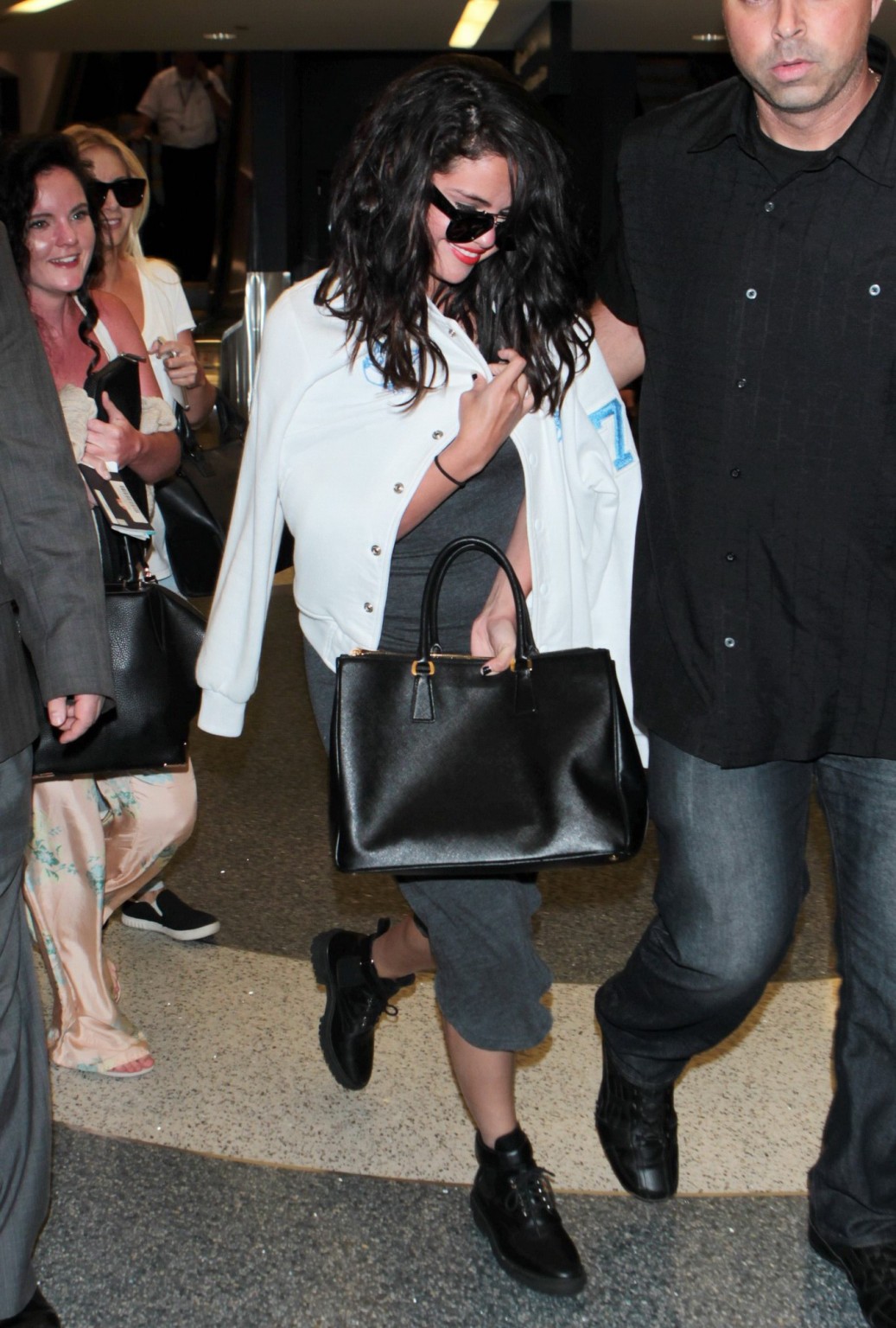Selena Gomez busty wearing a low cut dress at LAX Airport #75166567