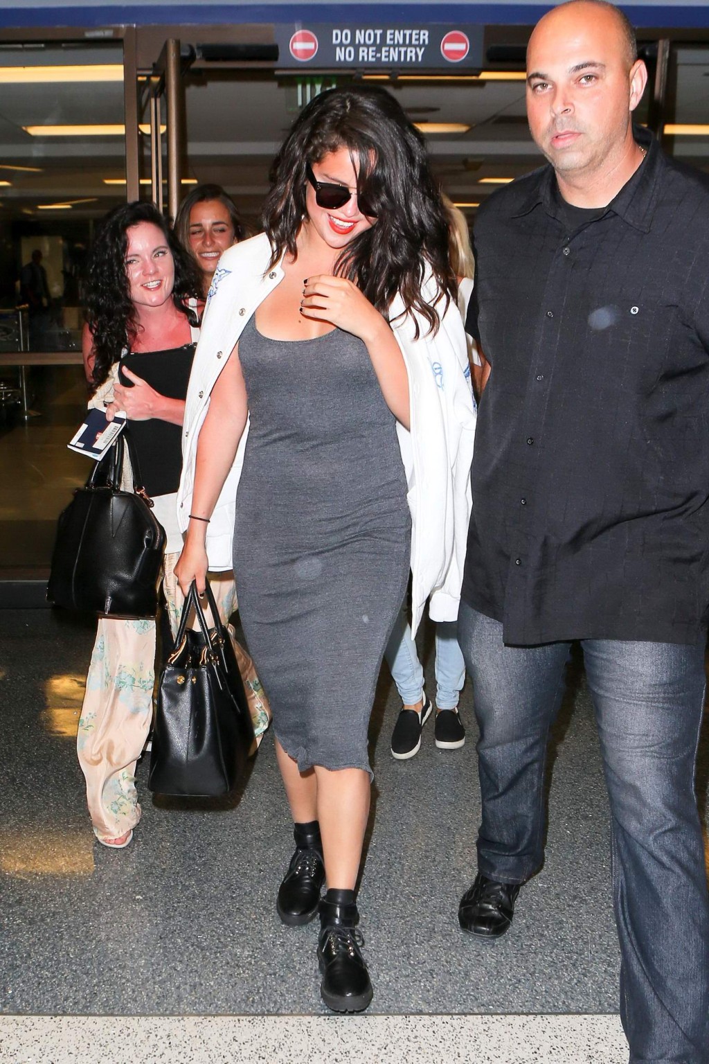 Selena Gomez busty wearing a low cut dress at LAX Airport #75166657