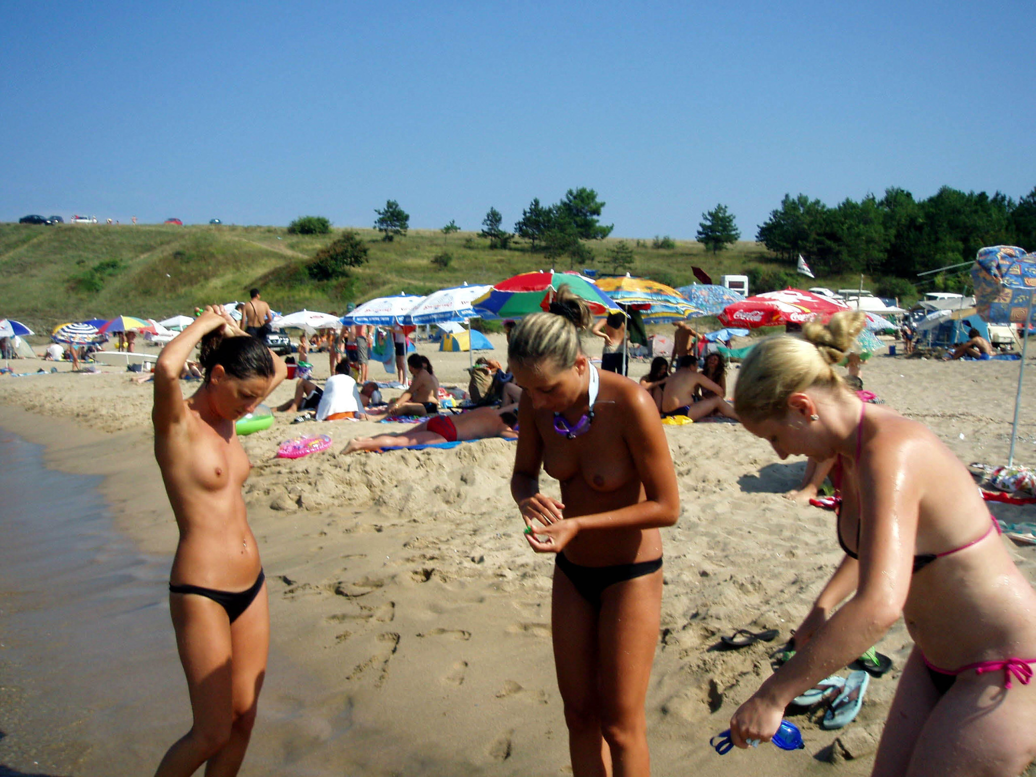 Sultry blonde girl strips and tans on a nude beach front #72249783