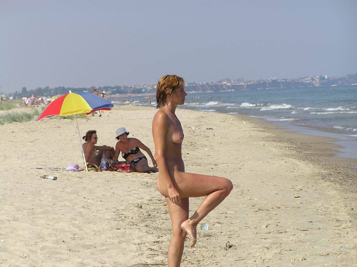 Une fille nue aux seins volumineux pose sur une plage nue
 #72250008